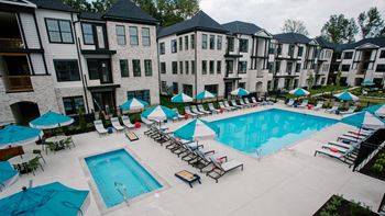 an aerial view of the resort style pool with chaise lounge chairs and umbrellas at Dalton, New Albany